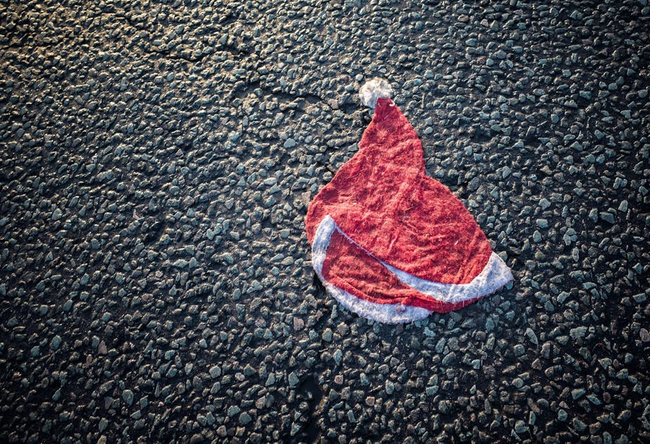 Wet and flattened Santa hat on a road