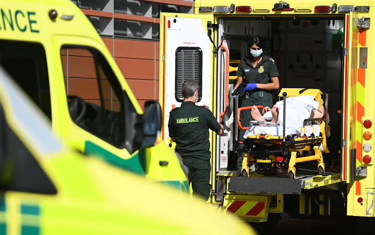 A person being transferred from an ambulance into hospital