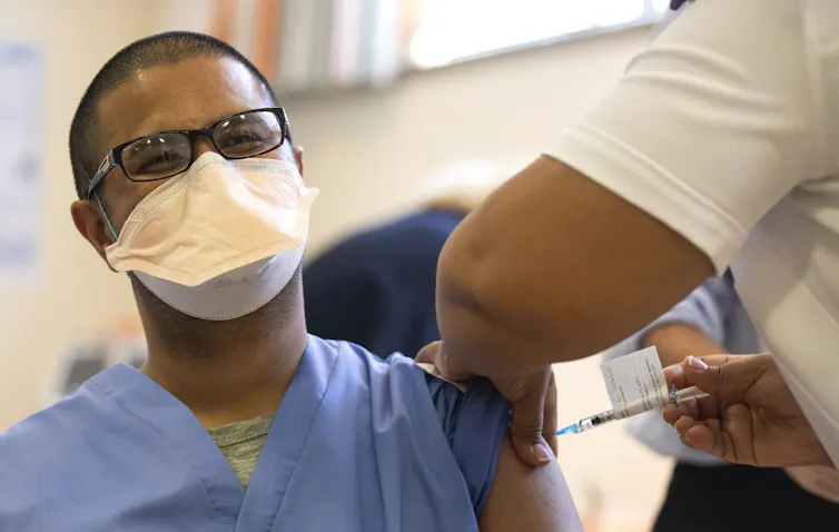 A health worker being vaccinated