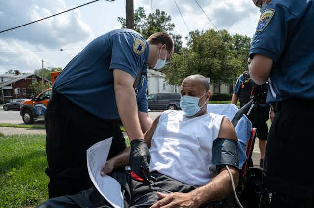 In Louisville, Kentucky, an emergency medical team responds to a man experiencing a COVID-19 emergency at his home.