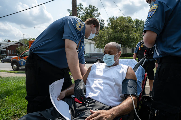 In Louisville, Kentucky, an emergency medical team responds to a man experiencing a COVID-19 emergency at his home.
