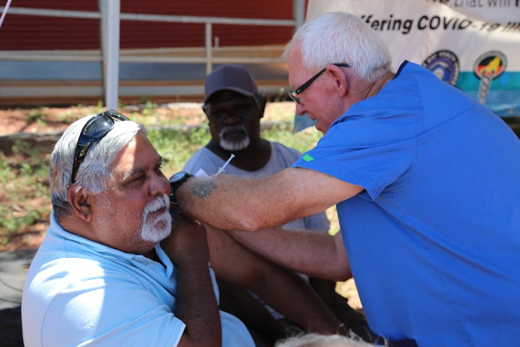 Aboriginal man receiving a vaccination.