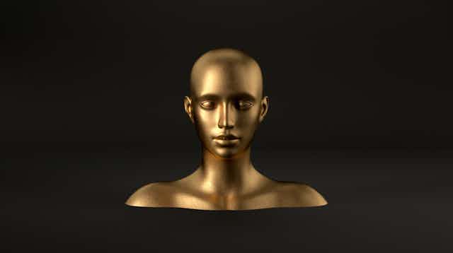 A gold 3D rendering of a mannequin head and shoulders, floating against a black background