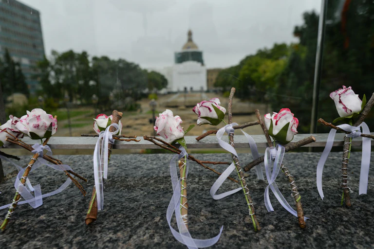 Wooden crosses with roses in front of Capital Plaza in Edmonton, Alberta, Canada, in honor of International Overdose Awareness Day