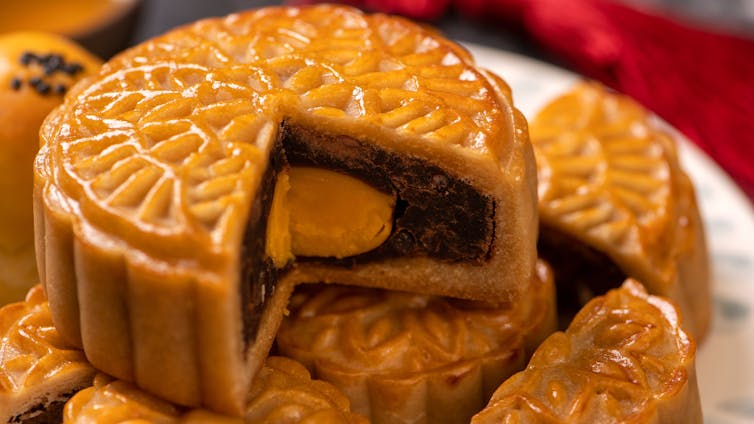 Plate of mooncake slices with yolk center.