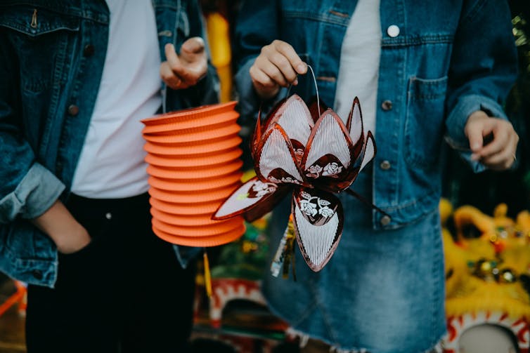 Two people holding lanterns.