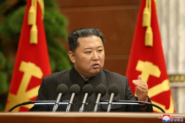 North Korean leader, Kim Jong-un makes a speech at a podium in Pyongyang, September 2021.