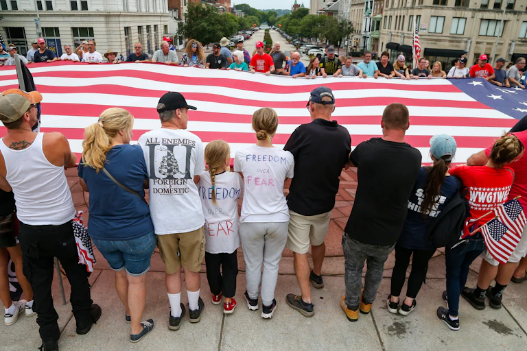 Protesters supporting a humongous American flag