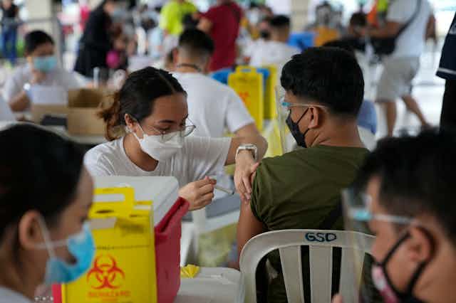 Person being vaccinated by health-care worker