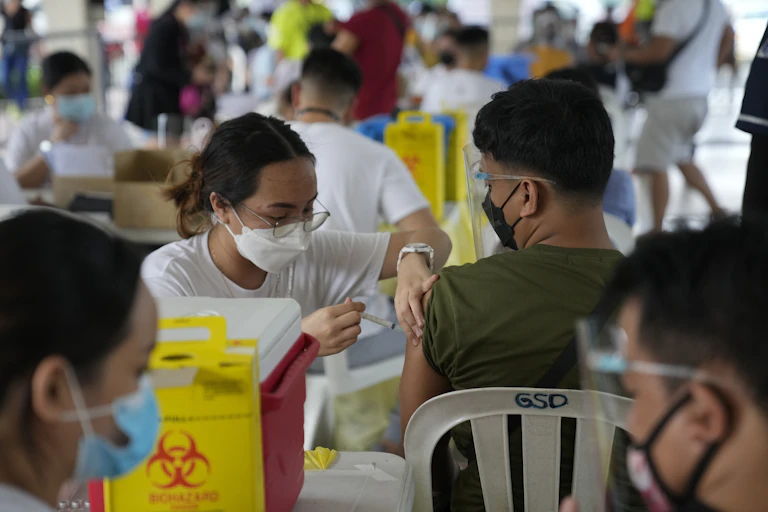 Person being vaccinated by health-care worker
