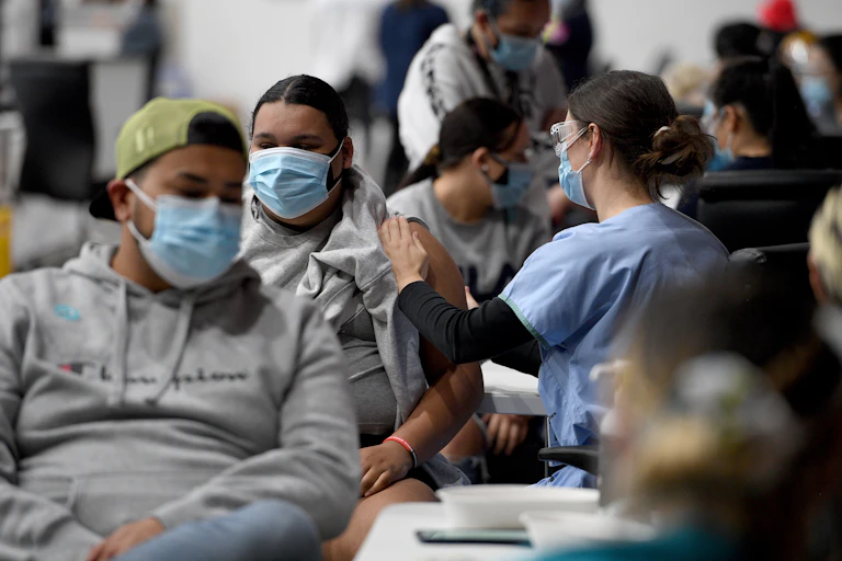 Indigenous community members receiving a Covid-19 vaccines at a pop-up vaccination clinic at the National Centre of Indigenous Excellence in Redfern.