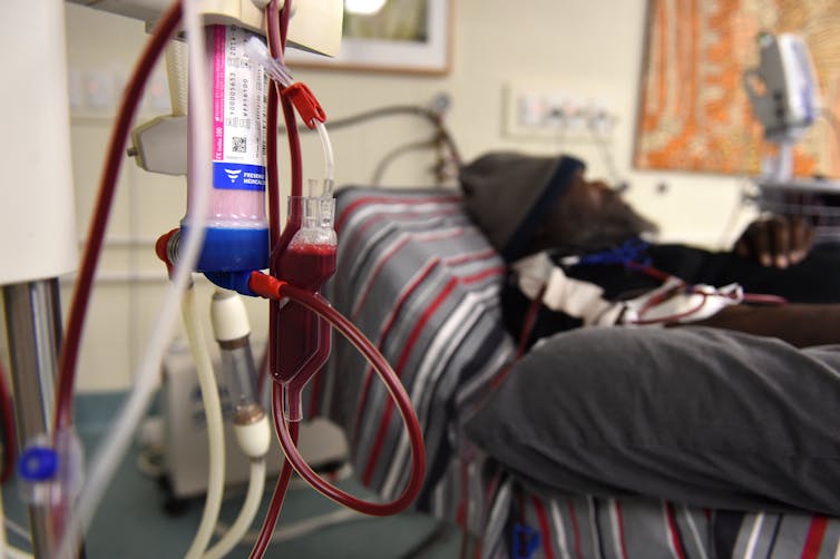 A senior Aboriginal man receives dialysis treatment.
