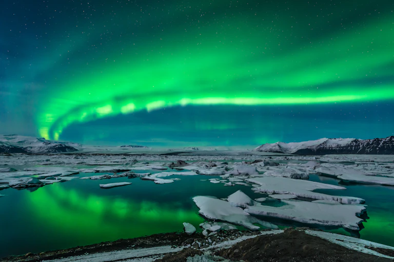 The northern lights over ice and water