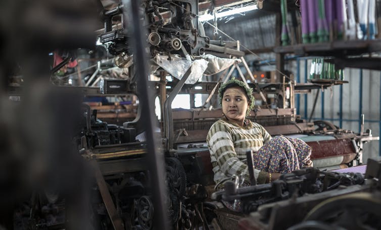A young woman working in a sewing sweatshop in Myanmar.