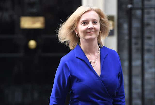 Foreign secretary Liz Truss wearing a blue dress, outside of Number 10 Downing Street