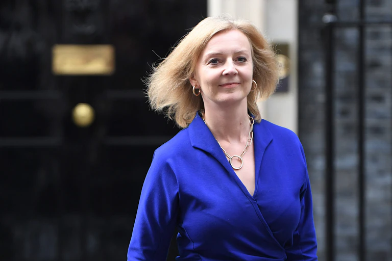 Foreign secretary Liz Truss wearing a blue dress, outside of Number 10 Downing Street
