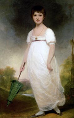 Woman in dress with green umbrella.