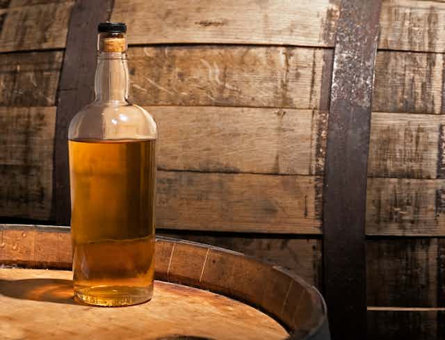 Whisky bottle on barrel