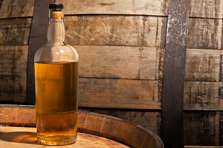 Whisky bottle on barrel