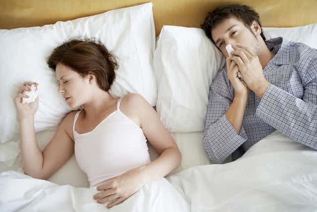 couple sick in bed