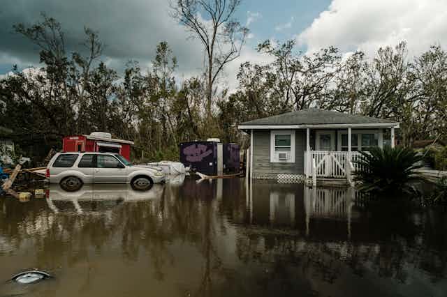 A single-storey home surrounded by flood water.