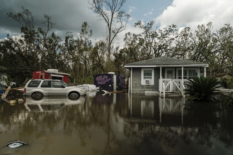 A single-storey home surrounded by flood water.