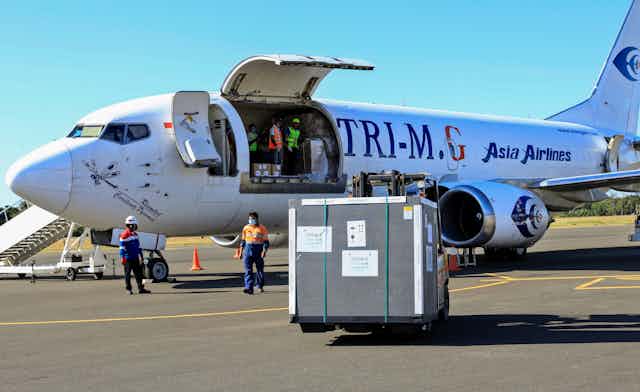 A Covax shipment being unloaded from a plane in East Timor