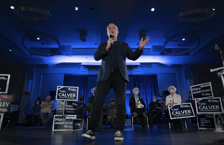 O'Toole speaks into a microphone on a stage.