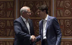 Scott Morrison and Justin Trudeau shake hands.