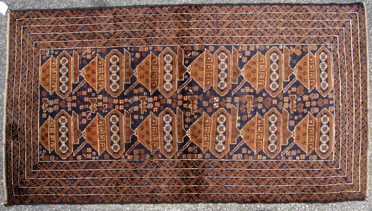 Rug featuring a tank pattern.