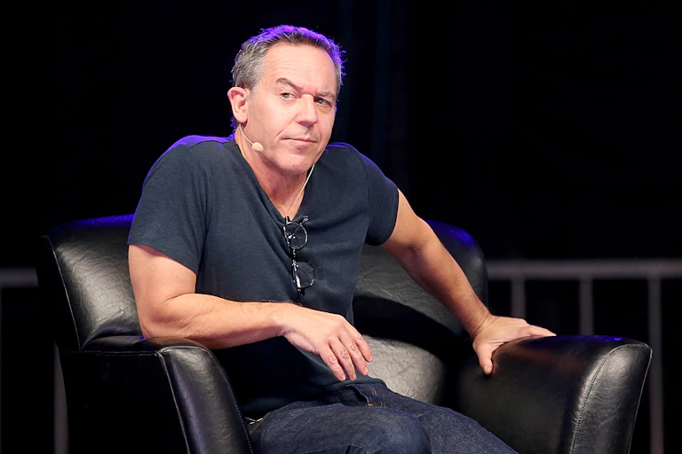 Man sitting in black chair raising one eyebrow.