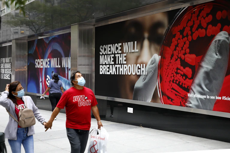 Man walks by billboard