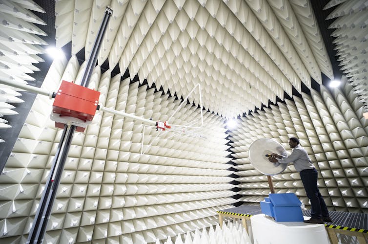 Worker testing 5G antenna