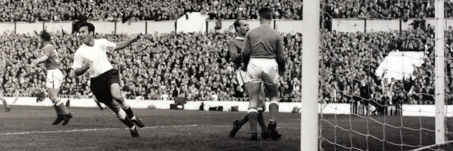 Tottenham Hotspur striker Jimmy Greaves turns to celebrate scoring a goal.