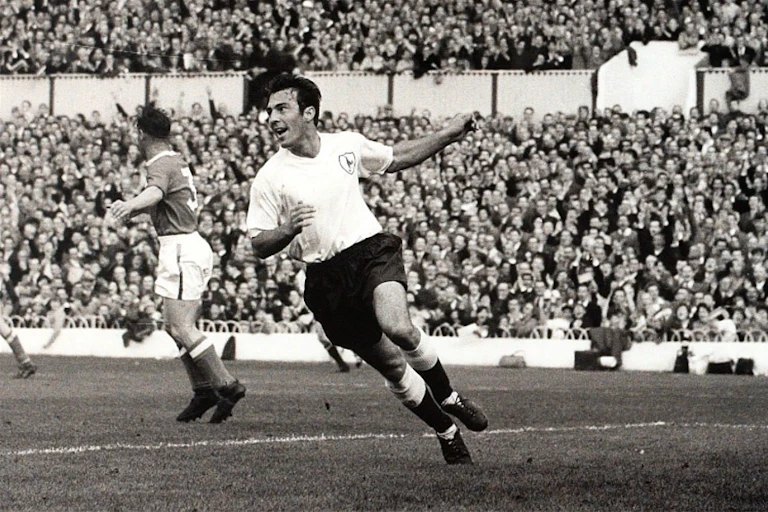 Tottenham Hotspur striker Jimmy Greaves turns to celebrate scoring a goal.