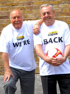 Jimmy Greaves and Ian St John holding a football and wearing t-shirts saying 'We're' and 'Back'.