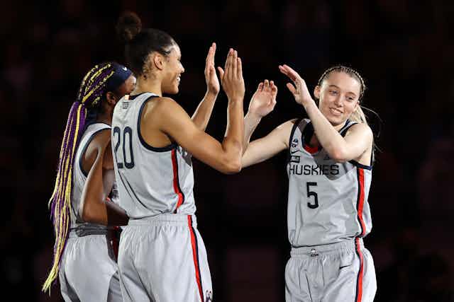 Women's college basketball players give each other high-fives