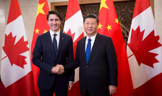 Trudeau shakes hands with Xi Jinping