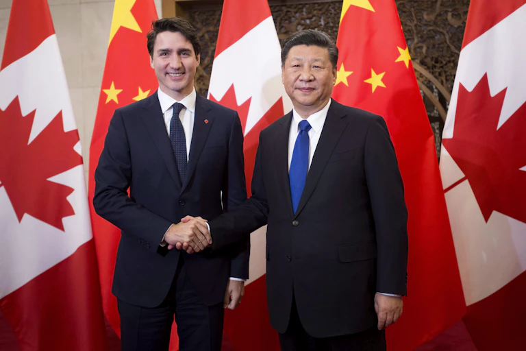 Trudeau shakes hands with Xi Jinping