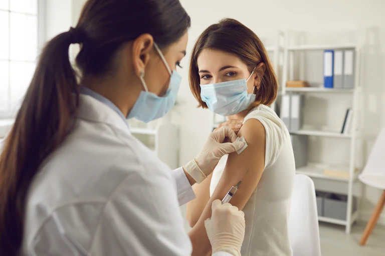 A woman being vaccinated for COVID-19