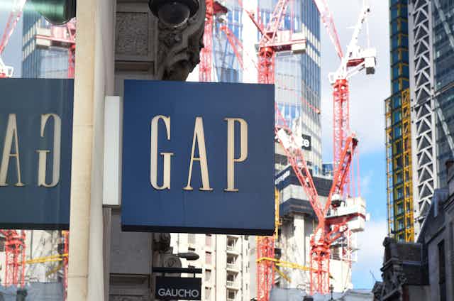 A Gap store sign with London backdrop.