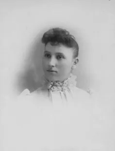 Studio portrait of a young woman in the late 1800s.
