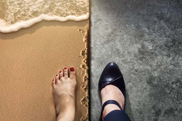 One foot on a beach and another in a high-heeled shoe