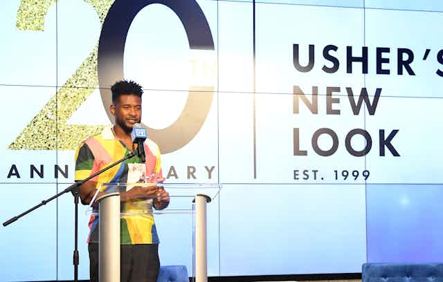Usher speaks at an event held by his New Look foundation