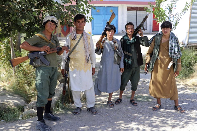 Militiamen loyal to a northern warlord pose for a photo