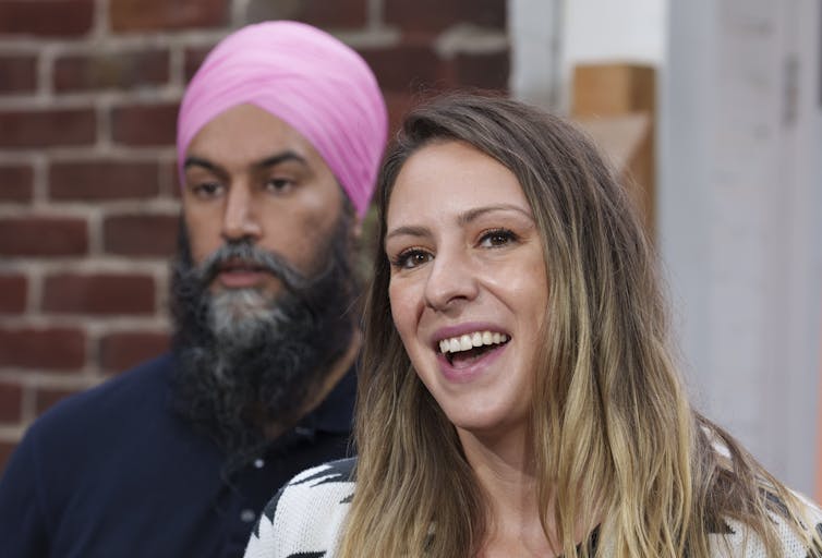 Candidate Ruth Ellen Brosseau in front of leader Singh