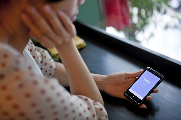 Woman using Facebook app