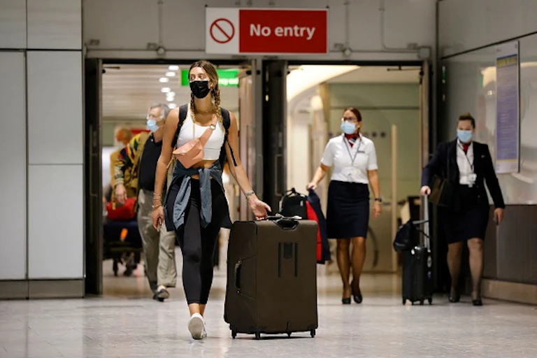 People walking with their luggage at an airport arrival hall