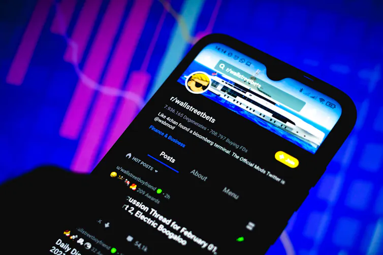 Silhouette of a trader using WallStreetBets on their phone