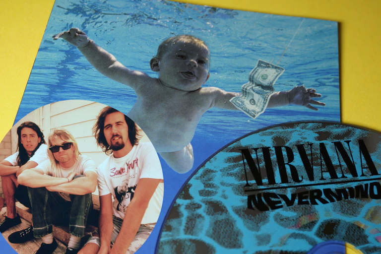 Nirvana Nevermind album cover, baby in swimming pool chasing a dollar